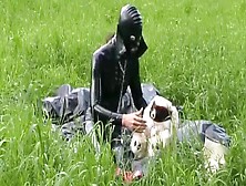 Rubber Whore Full In Dark Latex Catsuit And Mask Plays With Herself Outdoor In A Meadow - Part One