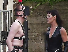 Leather Wearing Misstress Makes Her Gimp Prance Around In Big Black Boots