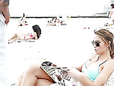 Lady In Blue Bikini Sits On Beach Chair To Go Sunbathing.
