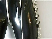 Redhead In Heavy Rubber And Metal Cuffs