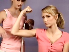 2 Young Girls Comparing Their Muscles