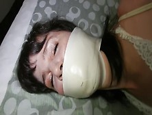 Microfoam Gagged Girl Struggles In Bondage