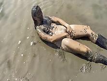 Nude Girl Playing In The Mud