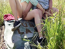 Two Brunettes Studying Each Other In A Grassy Area