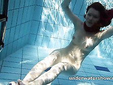 Redheaded Mia Stripping Underwater
