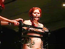 Gagged Redhead In Bondage Device Clamped And Spanked