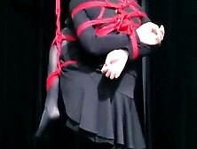 Student Girl Hanging By One Leg And Bound Up.
