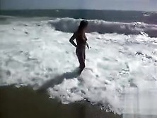 Busty Brunette's Lower Part Of A Bikini Drops As Huge Waves Hit Her
