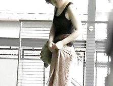 Asian Babe Has Her Long Skirt Torn By A Street Sharker.