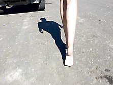 Woman In Short Shorts Walks Around Barefoot Outside On The Pavement