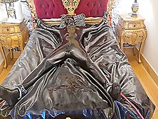 Latex-Encased Woman Tied To Bed