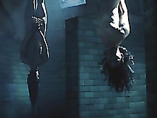 Two Asian Ladies Are Naked While Tied Upside Down In A Chamber.