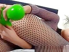 Chick In Fishnet Pantyhose Uses Cucumber Look A Like Dildo