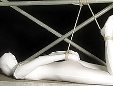 Babe Wrapped In White Zentai Suit Enjoys To Be Bondaged To A Metal Pole