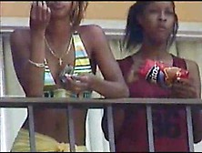 Black Lesbians Kissing On Hotel Balcony