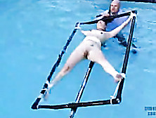 Blonde Girl Is Tied To A Rotating Device That Dips In Pool!