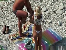 Couple Undressing In Beach