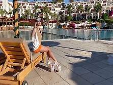Long-Legged Model Posing In Her Booty Shorts And High Heel Shoes Poolside