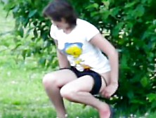 Young Brunette With Sexy Legs Pissing In The Bushes