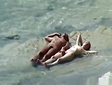 Nudist Couple Sunbathing And Refreshing