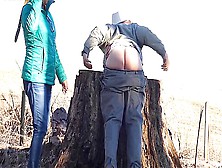 Naughty Man Fields The Belt While Bent Over A Stump