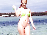 Hot Redhead Posing In Tiny Sling Bikini On The Public Beach