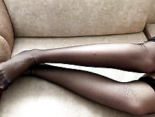 Girl In Black Stockings Caresses Her Long Legs