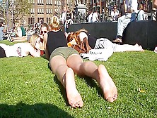 Cute Blonde Sunbathing Her Naked Soles And Feet On The Local Square