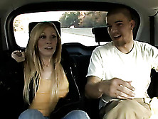 Lavish Blonde In Orange Shirt And Black Jacket Making Sure Her Body Is Noticed In A Car