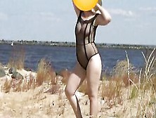 Good Woman Into A Nylon Bodysuit On The Beach