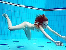 Dianas Redhead Beauty Enhances Her Swimming Grace