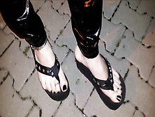 Crossdresser On A Public Street In Latex Leggings And Sexy Platform Flip Flops