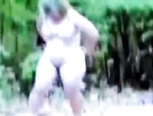 Mature Nude Female Undresses In Woods