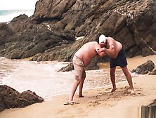 Men Wrestling On The Beach