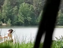 Girl Sunbathing On The Pond