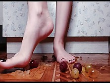 Female Feet With Dark Nail Polish Crush Grapes