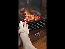 Wife Taking Socks Off Playing With Her Feet By The Fire