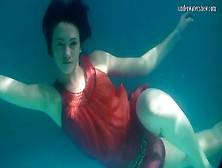 Mermaid Dressed In Red Rusalka Swimming In The Pool