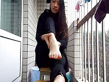 Pretty Asian On Patio Spreading Toes
