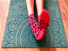 Gloria Gimson In Pink Socks Caresses Her Feet On A Yoga Mat