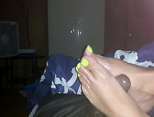 Passionate Woman With Yellow Toe Nails Giving An Ir Footjob