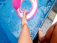 Having Fun With The Toes On The Side Of The Pool With The Buoy