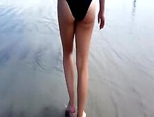 Saucy Girl Walks Around The City Beach In A Colorful Bikini