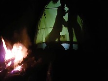 Shadow Sex In Tent Near Camp Fire