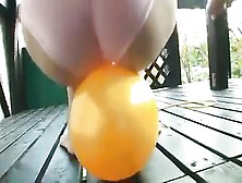Cute Asian Teen Playing With A Yellow Balloon