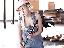 Young Blonde Sweeping A Warehouse In Her Overalls