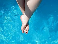 Holiday Feet Splashing In The Swimming Pool