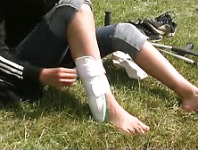 Girl Reapplying Aircast After Removing Black Sock And White Ankle Support