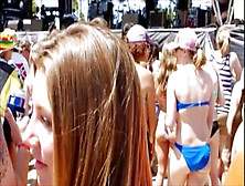 Candid voyeur scene with brunette in tiny top at a festival
