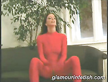 Glamourous Babe In Red Latex Body Suit Posing